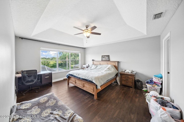 1236 Foxridge Pl, Melbourne, FL 32940 - bedroom featuring a raised ceiling, a textured ceiling, wood finished floors, and a ceiling fan