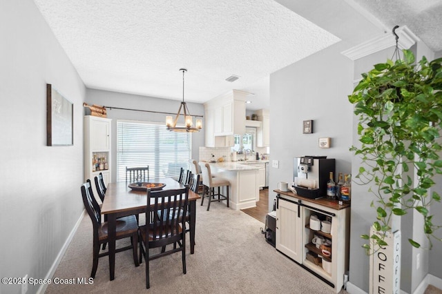 1236 Foxridge Pl, Melbourne, FL 32940 - dining space featuring a chandelier, light carpet, and a textured ceiling