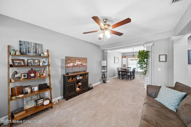 1236 Foxridge Pl, Melbourne, FL 32940 - living room featuring a ceiling fan, ornate columns, carpet floors, a chandelier, and a textured ceiling
