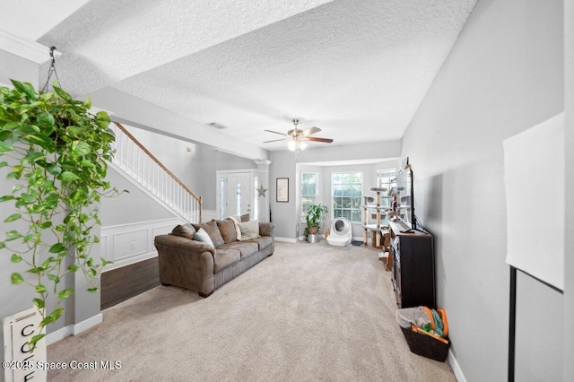 1236 Foxridge Pl, Melbourne, FL 32940 - living room with ceiling fan, stairs, a textured ceiling, and carpet flooring