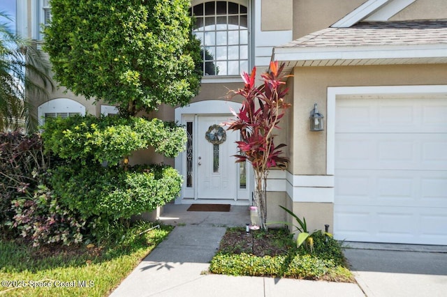 1236 Foxridge Pl, Melbourne, FL 32940 - doorway to property featuring stucco siding and a garage