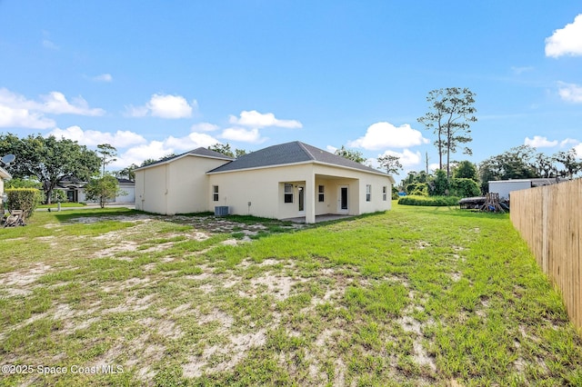 3977 Foothill Dr, Titusville, FL 32796 - rear view of house with stucco siding and central air condition unit