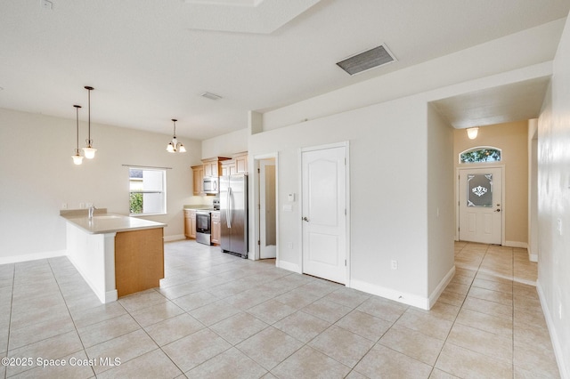 3977 Foothill Dr, Titusville, FL 32796 - kitchen with appliances with stainless steel finishes, a peninsula, light tile patterned floors, light countertops, and decorative light fixtures