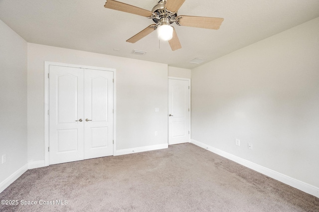 3977 Foothill Dr, Titusville, FL 32796 - unfurnished bedroom with carpet flooring, baseboards, a closet, and ceiling fan