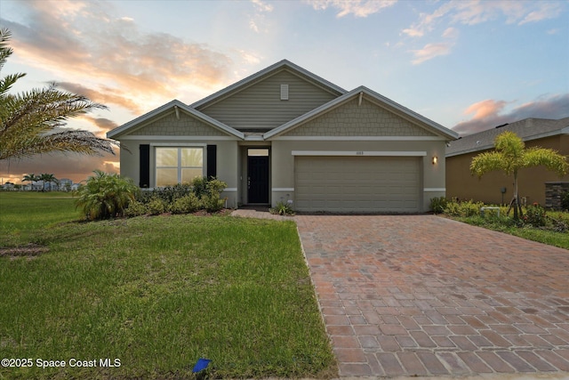 1103 Dunes Ave, Melbourne, FL 32904 - view of front facade featuring decorative driveway, a garage, a front yard, and stucco siding