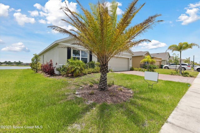 1103 Dunes Ave, Melbourne, FL 32904 - view of front of property with a garage, driveway, stucco siding, and a front lawn