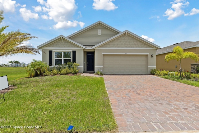 1103 Dunes Ave, Melbourne, FL 32904 - view of front of home featuring decorative driveway, a garage, a front yard, and stucco siding