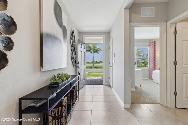 1103 Dunes Ave, Melbourne, FL 32904 - entryway with plenty of natural light and light tile patterned floors
