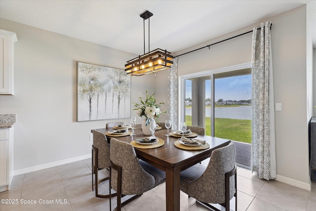 1103 Dunes Ave, Melbourne, FL 32904 - dining space with a water view and light tile patterned floors