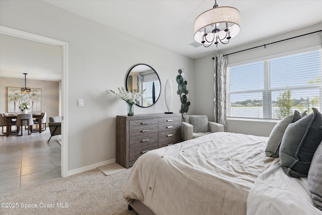 1103 Dunes Ave, Melbourne, FL 32904 - bedroom featuring a chandelier, multiple windows, light colored carpet, and light tile patterned flooring