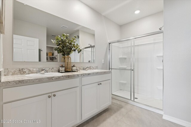 1103 Dunes Ave, Melbourne, FL 32904 - full bathroom with a stall shower, double vanity, and tile patterned floors