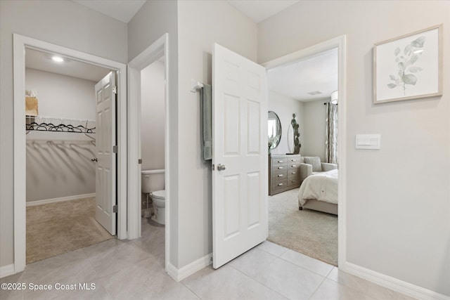 1103 Dunes Ave, Melbourne, FL 32904 - hallway with light carpet and light tile patterned flooring