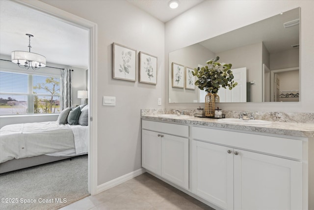 1103 Dunes Ave, Melbourne, FL 32904 - ensuite bathroom featuring double vanity, tile patterned flooring, and a chandelier