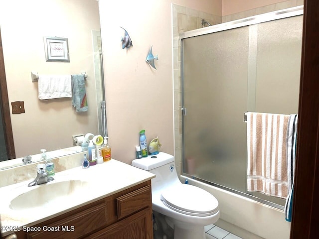 1796 Lambton St NW, Palm Bay, FL 32907 - bathroom featuring vanity, toilet, and bath / shower combo with glass door