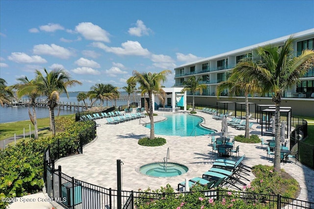 3031 Hafen Ln Unit 306, Melbourne Beach, FL 32951 - community pool featuring a patio area, a hot tub, and a water view