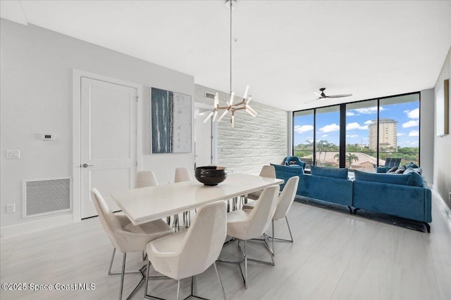 3031 Hafen Ln Unit 306, Melbourne Beach, FL 32951 - dining space with ceiling fan and expansive windows