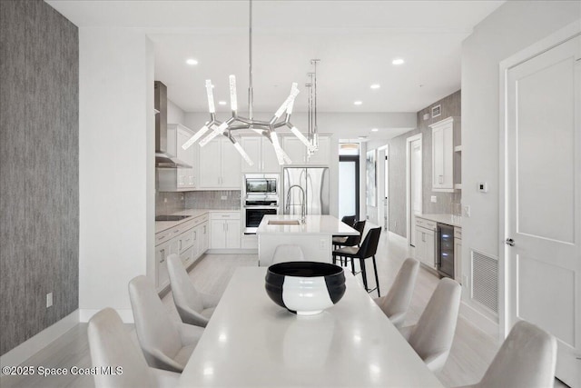 3031 Hafen Ln Unit 306, Melbourne Beach, FL 32951 - dining space featuring wine cooler, recessed lighting, and light wood-style floors