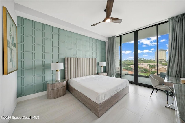 3031 Hafen Ln Unit 306, Melbourne Beach, FL 32951 - bedroom featuring a wall of windows, access to exterior, and ceiling fan
