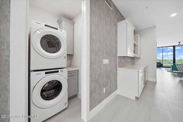 3031 Hafen Ln Unit 306, Melbourne Beach, FL 32951 - laundry room with estacked washer and dryer and cabinet space