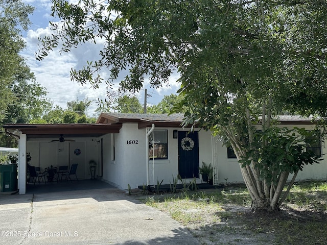 1602 Harvard Dr, Cocoa, FL 32922 - single story home featuring ceiling fan, an attached carport, concrete driveway, and stucco siding