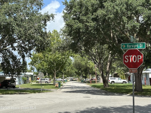 1602 Harvard Dr, Cocoa, FL 32922 - view of asphalt street featuring traffic signs