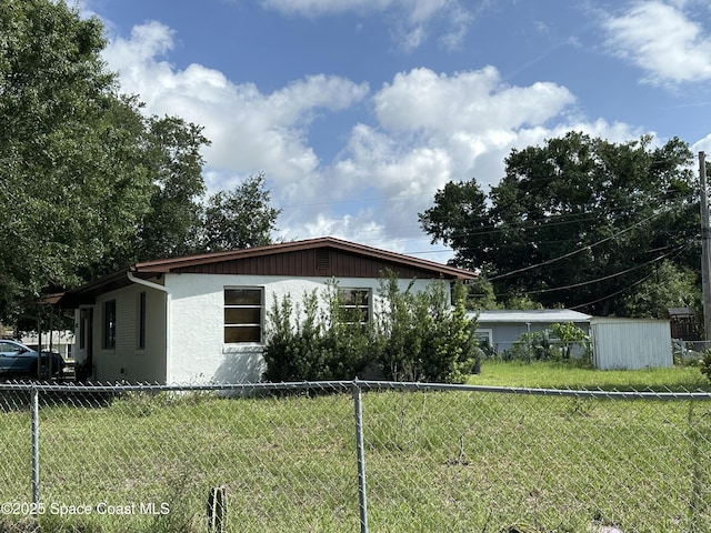 1602 Harvard Dr, Cocoa, FL 32922 - view of side of home featuring a storage shed and stucco siding