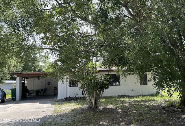 1602 Harvard Dr, Cocoa, FL 32922 - obstructed view of property featuring an attached carport, concrete driveway, and ceiling fan