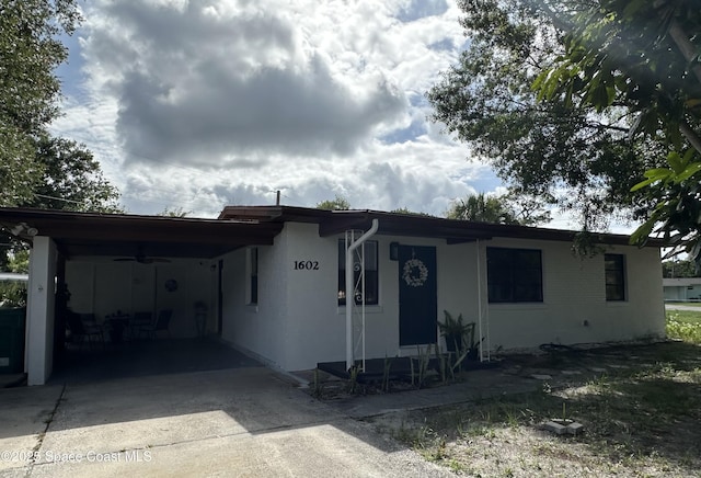 1602 Harvard Dr, Cocoa, FL 32922 - single story home featuring concrete driveway, a ceiling fan, and a carport