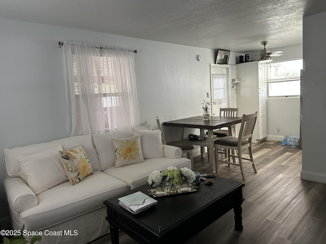 1602 Harvard Dr, Cocoa, FL 32922 - living room featuring wood finished floors, baseboards, a textured ceiling, and ceiling fan