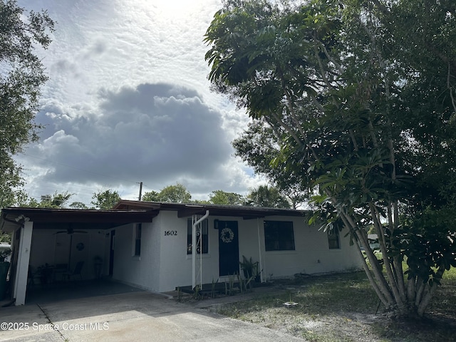 1602 Harvard Dr, Cocoa, FL 32922 - ranch-style house with an attached carport, concrete driveway, and stucco siding
