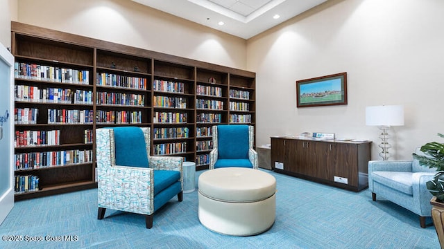 3485 Sansome Cir, Melbourne, FL 32940 - living area with bookshelves, carpet, and recessed lighting
