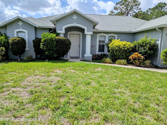 872 Ravenswood St SE, Palm Bay, FL 32909 - single story home featuring a front yard, stucco siding, and roof with shingles