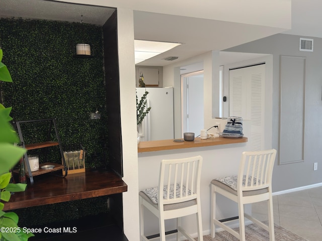 933 Sonesta Ave NE Unit 208, Palm Bay, FL 32905 - kitchen with freestanding refrigerator and tile patterned floors
