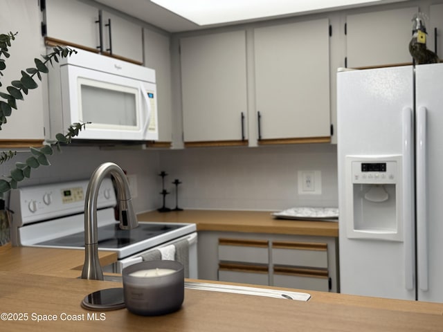 933 Sonesta Ave NE Unit 208, Palm Bay, FL 32905 - kitchen featuring white appliances and light countertops
