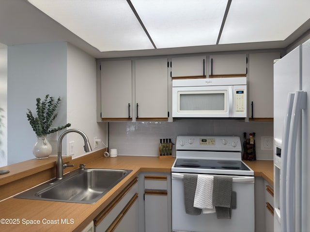 933 Sonesta Ave NE Unit 208, Palm Bay, FL 32905 - kitchen featuring white appliances, light countertops, gray cabinetry, and backsplash