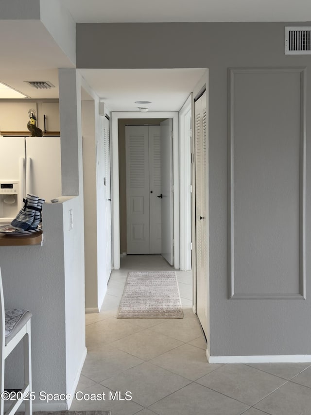933 Sonesta Ave NE Unit 208, Palm Bay, FL 32905 - hallway featuring tile patterned floors and baseboards