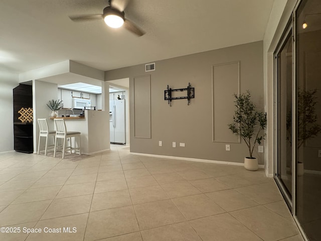 933 Sonesta Ave NE Unit 208, Palm Bay, FL 32905 - unfurnished living room featuring ceiling fan and light tile patterned flooring