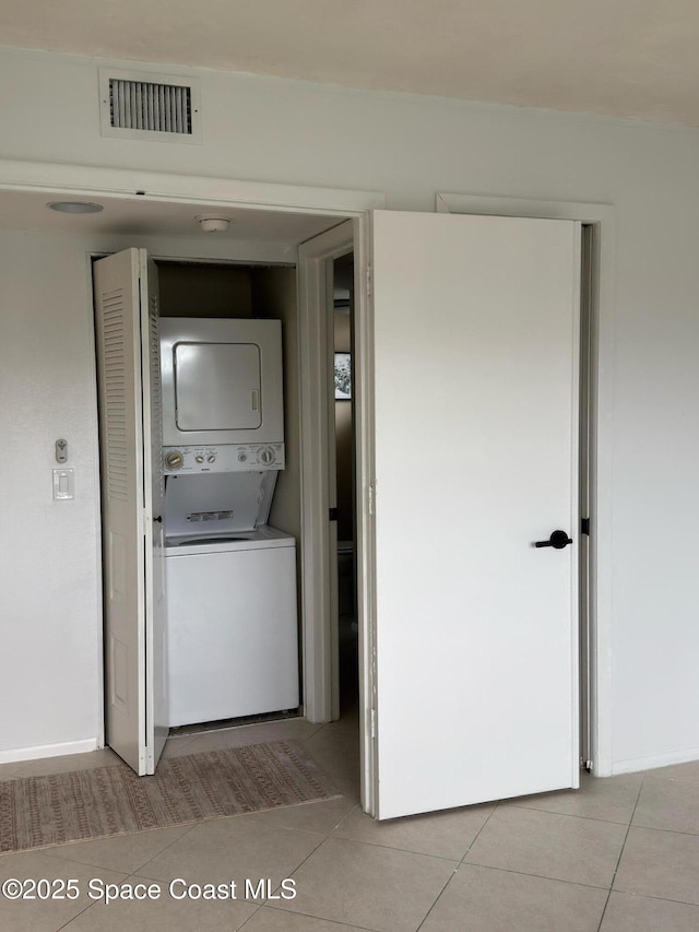 933 Sonesta Ave NE Unit 208, Palm Bay, FL 32905 - laundry area featuring stacked washer and clothes dryer and light tile patterned floors