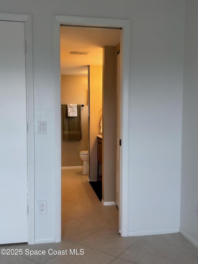 933 Sonesta Ave NE Unit 208, Palm Bay, FL 32905 - corridor featuring baseboards and light tile patterned floors