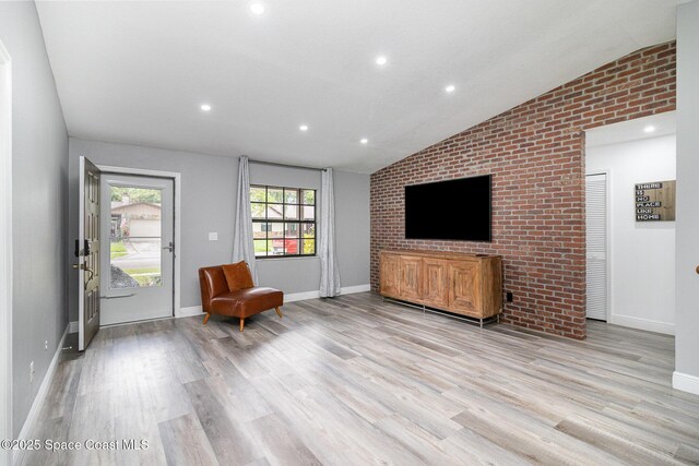 813 Laurel Dr, Rockledge, FL 32955 - living area featuring vaulted ceiling, light wood-style floors, recessed lighting, baseboards, and brick wall