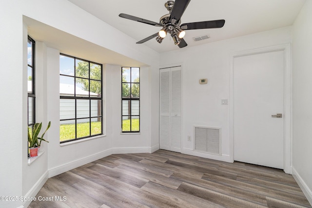 813 Laurel Dr, Rockledge, FL 32955 - empty room featuring a ceiling fan, wood finished floors, and baseboards
