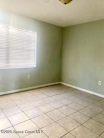 2170 Knox Mcrae Dr Unit 2, Titusville, FL 32780 - empty room featuring baseboards and light tile patterned floors