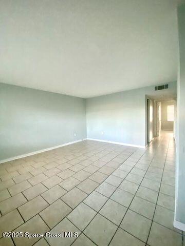 2170 Knox Mcrae Dr Unit 2, Titusville, FL 32780 - empty room featuring light tile patterned floors and baseboards