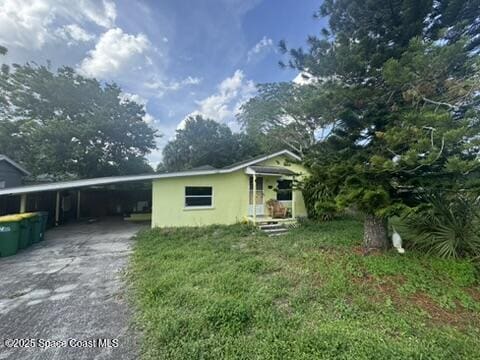 1236 Jackson St, Cocoa, FL 32922 - view of front of property with driveway, an attached carport, and stucco siding