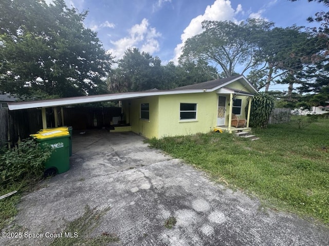 1236 Jackson St, Cocoa, FL 32922 - ranch-style home featuring driveway, stucco siding, and a carport