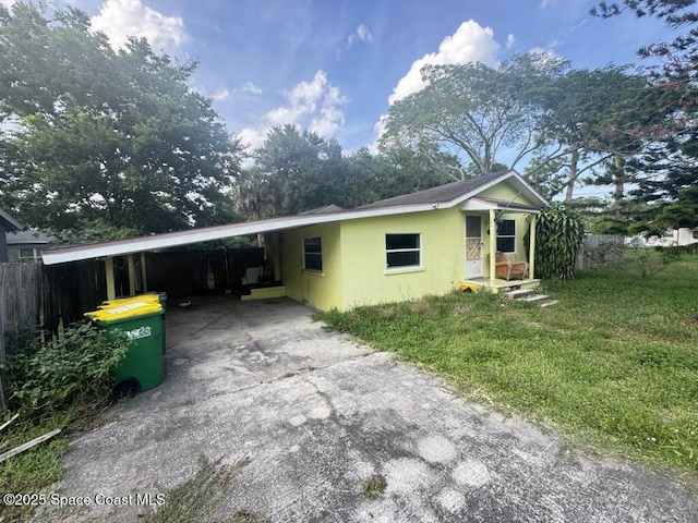 1236 Jackson St, Cocoa, FL 32922 - view of front of house with concrete driveway, stucco siding, and a carport