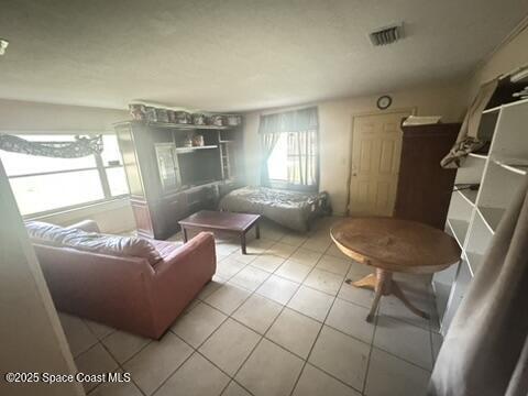 1236 Jackson St, Cocoa, FL 32922 - living room featuring healthy amount of natural light and tile patterned floors