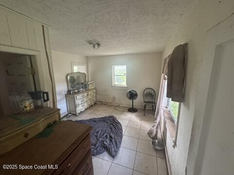 1236 Jackson St, Cocoa, FL 32922 - living area with light tile patterned flooring and a textured ceiling