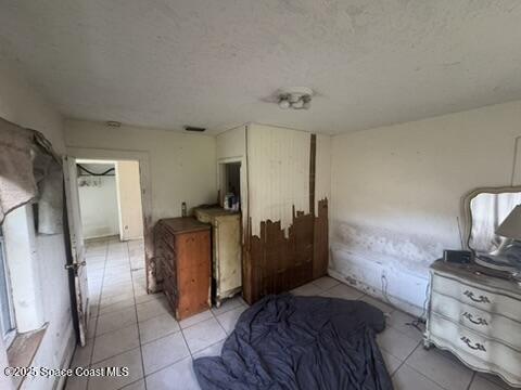 1236 Jackson St, Cocoa, FL 32922 - bedroom featuring light tile patterned flooring and a textured ceiling
