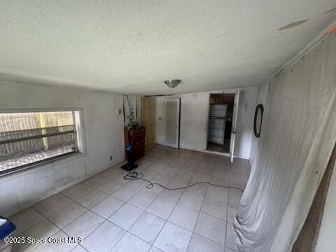 1236 Jackson St, Cocoa, FL 32922 - empty room with a textured ceiling and light tile patterned floors